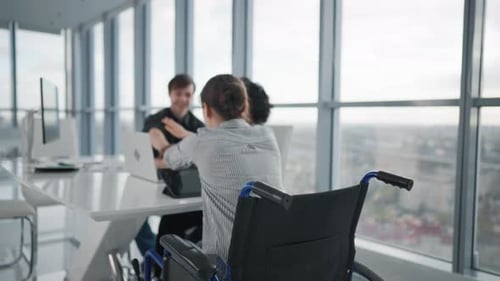 Friendly Colleagues Working on Project in Modern Office Together Sitting at Desk Woman in Wheelchair