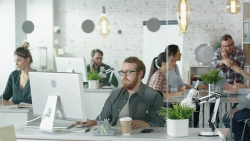 Weekday in a Busy Creative Bureau. Office People Working at Their Personal Computers, Talking on th