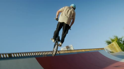 BMX Rider Performing Air Trick above Skatepark Ramp