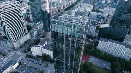 Aerial orbit over the city center of a modern capital with glass facades of skyscrapers