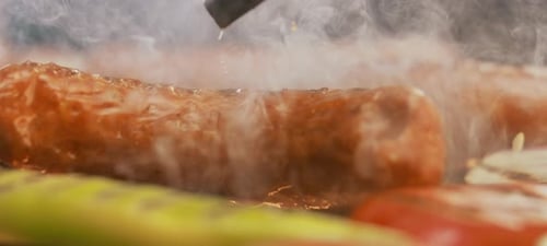 Sausages grilling on the grill pan