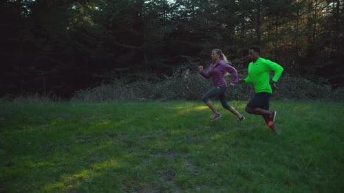 People running in slow motion outdoor exercise at the park on a sunny day