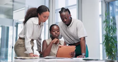 Team Collaborates Viewing Tablet in Office