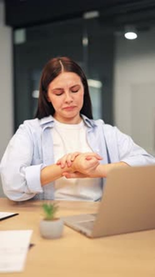 Discomfort Leads Office Worker To Rub Aching Wrist