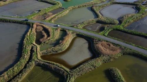 Aerial View of Cars Driving Through Rural Landscape