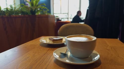 Coffee and cake on table in cafe setting