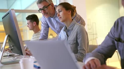 People, tech and advice in office for web design, planning and webpage layout discussion.