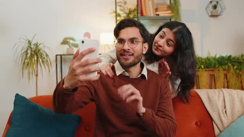 Man and Woman Video Call in Living Room