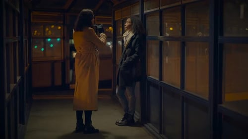 Two Women Talking at Night in Shelter