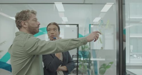 Business People in Casual Office Meeting, Sticking Notes on Glass wall