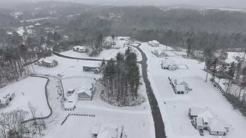 Snow-covered Single Family houses in american suburb during winter season. Aerial top down establish