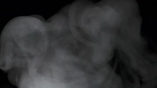 Slow motion of white smoke, fog, mist, vapor on a black background.
