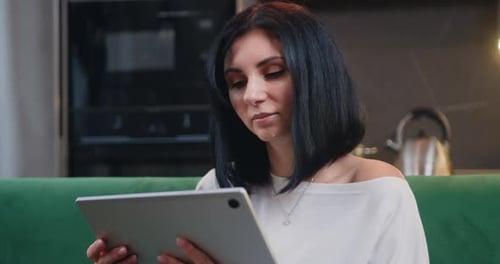 Woman Using Tablet in Modern Home
