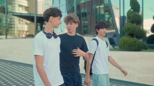 Teenage Boys Walking and Talking Together in City