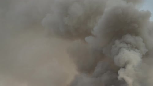 Billowing Gray Smoke Plume Rising