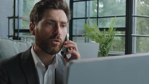 Adult Man Anxiously Talking on the Phone