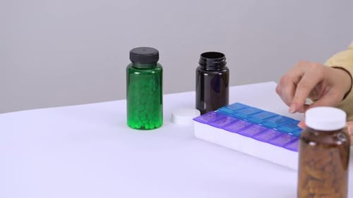 Woman Sorting Pills Into Pill Organizer