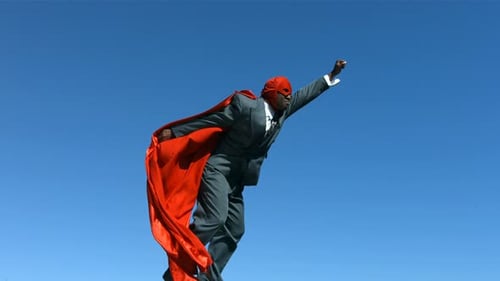 Man in Superhero Costume Flying Through the Air