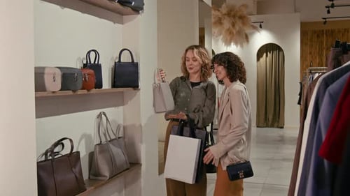 Young Women Shopping for Fashion Handbags in Store