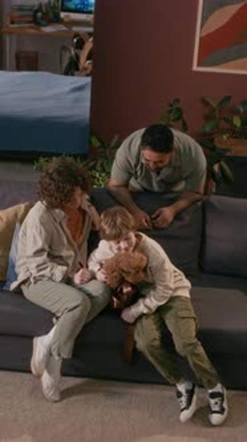 Family bonding petting their dog on the couch