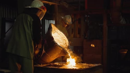 Team Pouring Molten Iron in Foundry