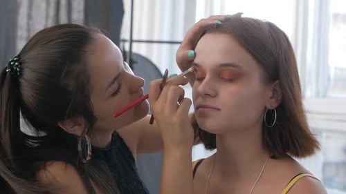Makeup Artist Applying Makeup to Model's Face Close Up View