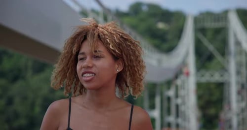Young African American Woman Runner Jogging on City Bridge Outdoors