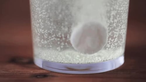 Effervescent Tablet Dissolving in a Glass of Water