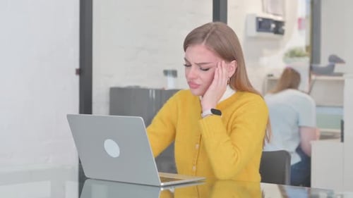 Woman Working on Laptop with a Headache