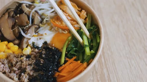 Bibimbap in Bowl with Chopsticks close up