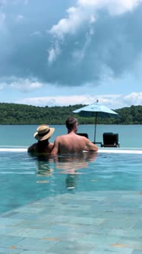 Couple Men and Women Relaxing in a Swimming Pool During Vacation in Thailand