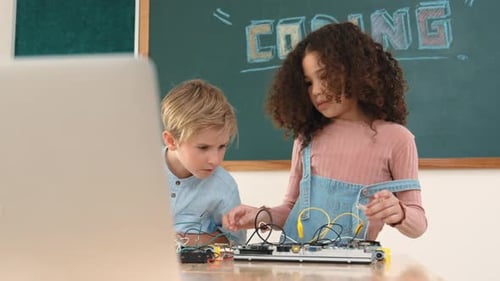 Children coding project in classroom working together learning