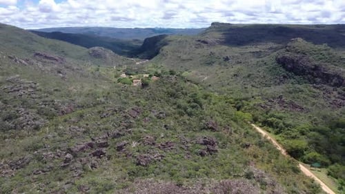 an old building complex among the vast barren hills. 4K aerial videos. summer season. from top to bo