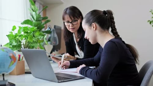 Teen Girl Learning at Home with Adult Woman
