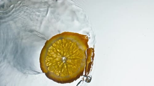 Delicious Orange Slices Splashing Smooth Water Closeup. Fresh Tropical Fruit Pieces Falling