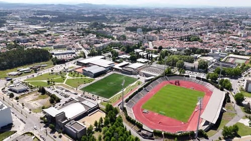 Aerial View of City with Sports Complex on Sunny Day