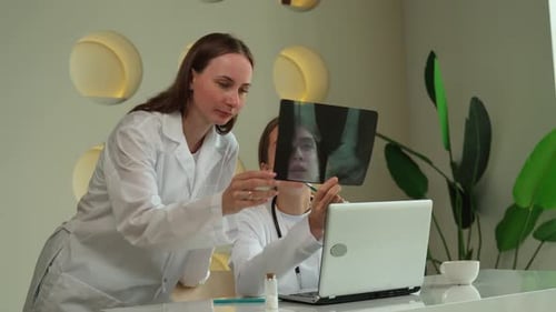 Doctors Reviewing X-ray in Modern Office Setting