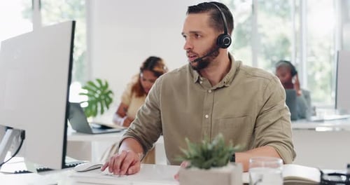 Call center, customer service and man talking, typing and on call with client, working on computer