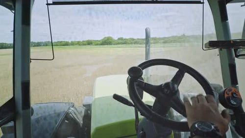 Agriculture Tractor Driver Point of View. Driving Tractor on Agriculture Field. Tractor