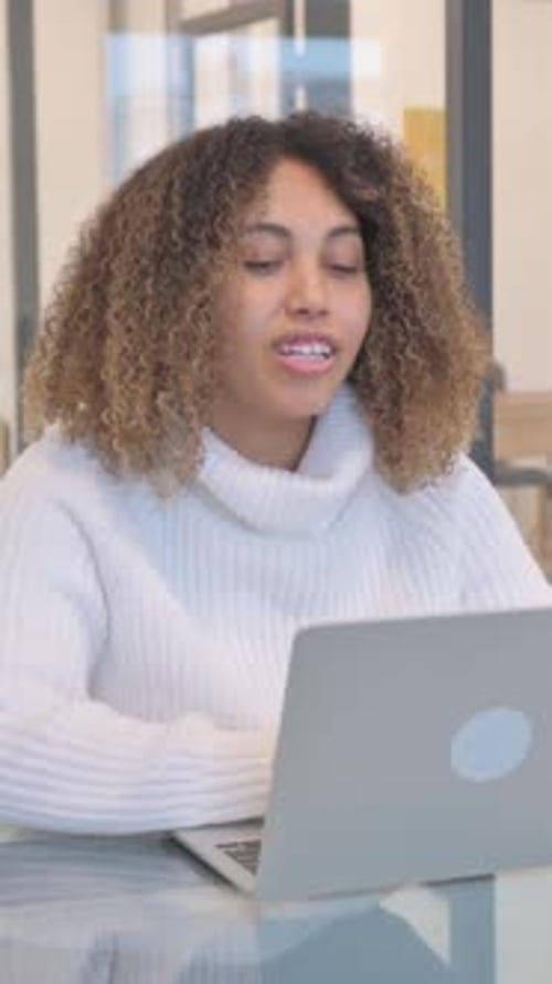 Woman Video Calling on Laptop in Modern Office
