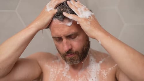 Man Washing Hair with Shampoo in Shower
