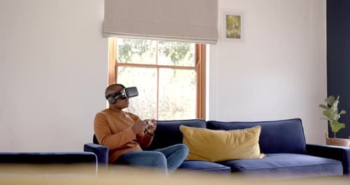 Young Adult Immersed in Virtual Reality at Home