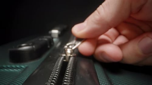 Hand Zipping Black Luggage Close Up