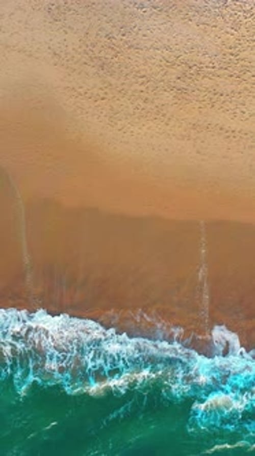 Aerial Drone Captures Scenic Sea Waves on Sandy Coastline