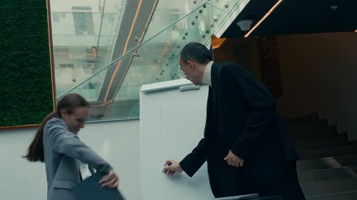 Office Couple Dancing in front of Flipchart during Business Presentation