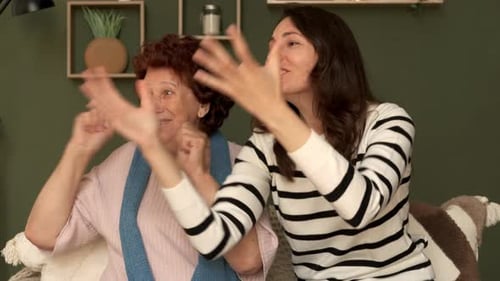 Senior Woman and Adult Woman Dancing at Home