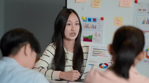 Young Adults Presenting Data in Modern Office