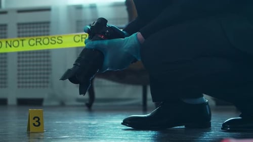 Investigator photographs evidence at indoor crime scene