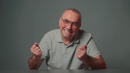 Man Clenching Fists and Grinning