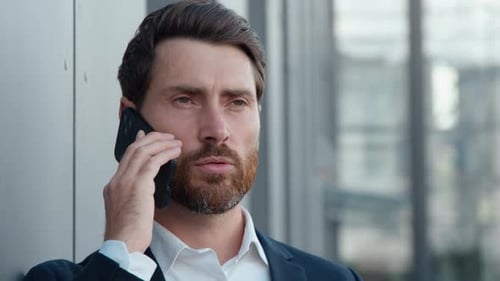 Bearded Man Talking on Phone Wearing Business Suit